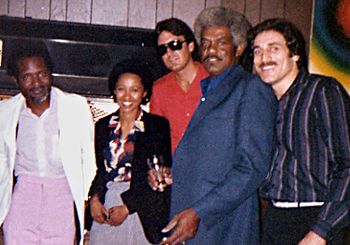 A "family" portrait: Sonny Lane and girlfriend with Rod Piazza, Mississippi Johnny Waters and Rick Estrin (1981)