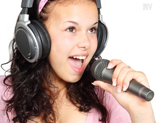 Woman singing with headphones and microphone