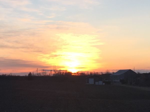 Sun setting over a rural scene