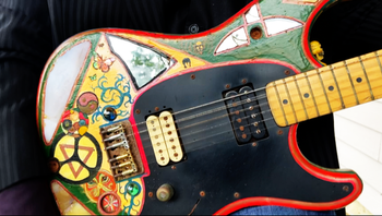 Jon's famous customized guitar. It was decorated with paint, tile, mirrors, and other trinkets by his friend and former IOSIS band mate Scott Summers.