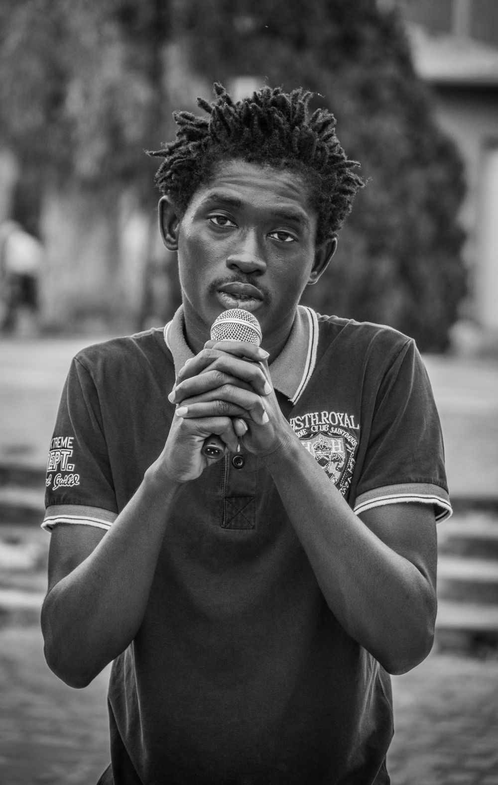 Lucky Boy's Verse on "In Libya": "From prison to prison, it is never stop Many times on the boat, people getting shot. It’s not easy being black on the street, They kidnap you, chain hands and feet. Each and every one, they have a gun Paid for by the European Union. Police is criminal, criminals are police So much corruption there can’t be peace. People listen up, to my story One year in this purgatory. Beaten every day, made into a slave My brothers and sisters forced to their grave. Like great prophets, I made a long journey From Gambia to Senegal to Mali. Mali to Burkina to Niger On this journey I’ve seen so many tears."