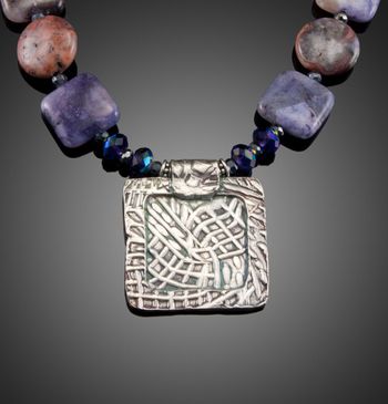 Which Way Do We Go? - fine silver framed pendant with Charoite stones.McKenzie's Jewelry by Nancy Koehler. SOLD