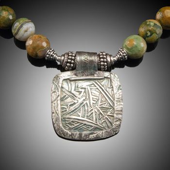 After Effect - fine silver pendant with hand carved texture. Stones are Ryolite Jasper and Rainforest Jasper. McKenzie's Jewelry by Nancy Koehler. SOLD