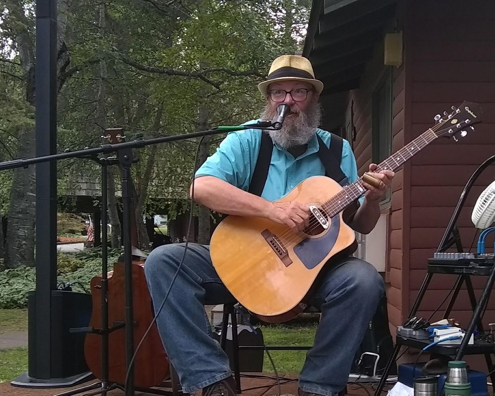 Bruce Archer singing and playing slide guitar