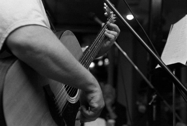 Danny Adlerman playing guitar at Open-Mic Night