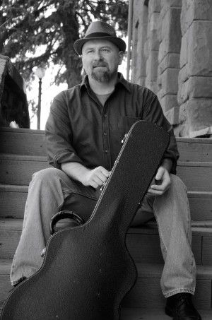 Chuck Cheesman with guitar in Flagstaff