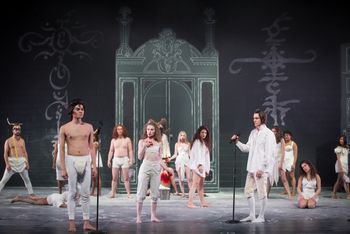 Christopher Cartmill's production of Goethe's Faust — It's only a play Goethe's FAUST directed by Christopher Cartmill, set design by Bo Ra Kwan, costumes by Sarah Zinn and lighting design by Catherine Cusick — pictured Mr. At-Your-Service (Ashley Baker) and Ensemble — photo by Matt Pilsner