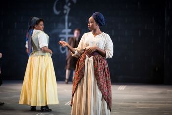 Christopher Cartmill's production of Goethe's Faust — She's a witch Goethe's FAUST directed by Christopher Cartmill, set design by Bo Ra Kwan, costumes by Sarah Zinn and lighting design by Catherine Cusick — pictured Citizen (Khandis Merritt) and Old Woman (Tshiwela Nematswerani) photo by Matt Pilsner