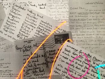 John Lennon Close Up This wall hanging features a fabulous collection of John Lennon lyrics, letters and notes penned in his own handwriting with the classic self-portrait laid out on top in colored, lighted wire (EL wire).
