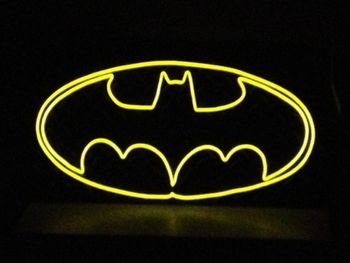 Batman This wall hanging features the classic Batman symbol in colored, lighted wire (EL wire) on top of a 12" high x 24" wide x 1/16" thick black, diamond tread plate.