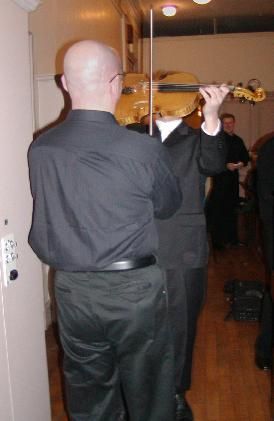 Also backstage at the Paris Opera 2/06 - I'm holding the violin bow stationary as the violinist moves the instrument up & down to play something along the lines of "Flight Of The Bumble Bee"....it was amazing to see!