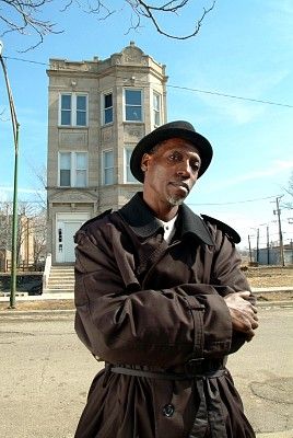 Larry outside 1131 S. Mozart, where he grew up. Photo 2004 by James Fraher, for cover of Larry's CD "They Were in This House."