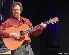 Andrew onstage with acoustic guitar at Franklin Park Arts Center, photo by Jim Poston