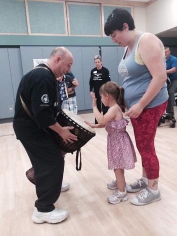 Letting Miss Ella play the Djembe MOVE Performance with the Ellen Sinopoli Dance Company at the Center for Disabilities Langen School 1of 7