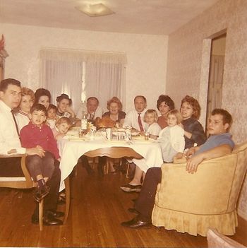 Holiday Family Gathering Another picture of my immediate family many years ago, during the Holidays, where I am sitting on my father's lap as a young kid. I believe this picture was taken by my Uncle Nicky, at my grandparents 2nd home on Long Island...