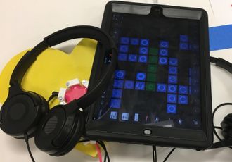 Portable Ipad learning station with headphones, can be cable locked in place. User can't leave app.