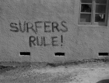 might have been a clean cut time, but surfers were still a breed unto themselves!!! The old Waipu SLSC clubhouse getting the once over by those fanatical surfers!!