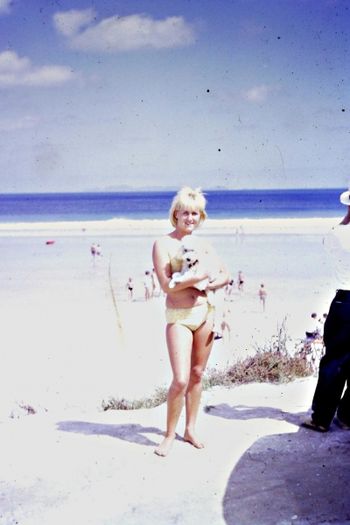 Kandy getting a cuddle from a cute blonde beach girl!!.......... Hey wait a minute isn't that Mary Alach trying to trick us with the blonde hair!!........i wonder what her Hodad bikey brother 'Junior would look like with blonde hair ...Ha!