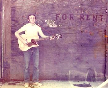 Playing on Beale Street in Memphis back in the late 1970s I would say. Before Beale St. was revitalized.
