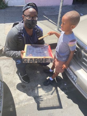 Peace to the father and young son on the move. International & Miller, East Oakland, CA. Garvey Drums 2021.