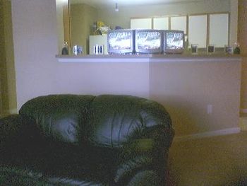 Once again the frontal view from the leather loveseat to the multitelevisons on the counter. We do it Big Willie Style....