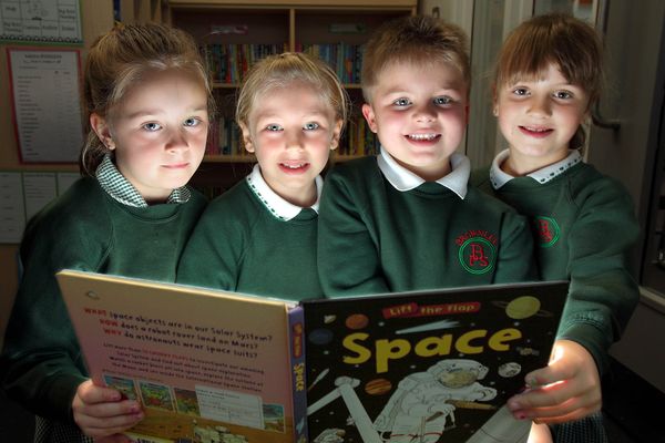 Keeley, Amy, Morgan and Olivia enjoy reading a book as part of our Project 500 partnership with Queen's University.