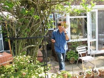 Here's Ian on the phone the week before our tour coordinating the radio interview we did on WinFM. We're in a friend's backyard on Hayling Island.