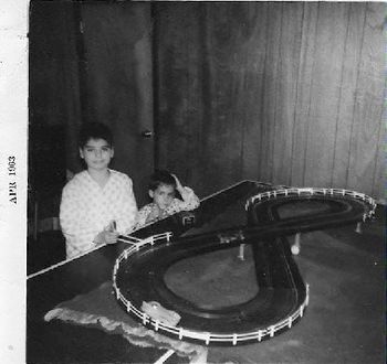 Me and bro Mike making many left hand turns. Mike, can you look more bored? They don't make race car sets like that anymore! (Eldon) See the ping pong ball under the overpass? Dad finished this bas
