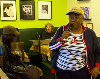 Larry Taylor watches Gloria Shannon sing with Bonni at Beverly Bakery, a stop in the 2015 Beverly Art Walk