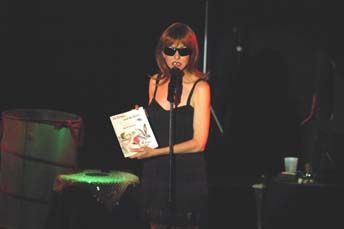 "One Voice" live show image - Bethany reads the fable of the "Rabbit and the Hare" to the audience as Arnold Schwarzenegger's Mom