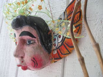 A Mexican angel which I've had hanging next to my front door for several years now. I have another Mexican angel hanging at the back door. I love the facial expressions on the Mexican angels! They l