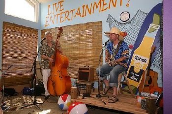 The front room where the concert took place. A mini-pier for a stage, lotsa sand, lotsa stuff on the walls. Nine TONs of Sand inside the whole house, where me and bassist Pat did a 50th Birthday Beach