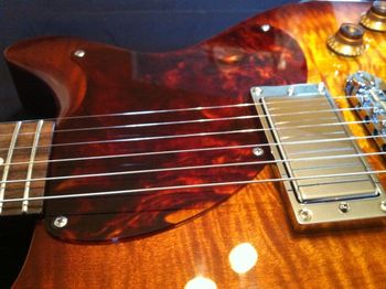 The pickguard was cut from a choice piece of Tortoid hand-cast acrylic. Every detail is addressed, including hand polishing the edge of the new pickguard.