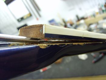 The fretboard had popped loose when someone attempted to adjust the truss rods....THE WRONG WAY.....