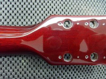 After the lacquer has cured thoroughly, I wet sand up to 12000 grit, and hand polish to a factory-appearing gloss