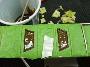 2-part epoxy is tinted with pigment to closely match the color of the rosewood fretboard. Experience has taught me how to mix the color just right.