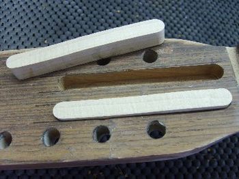 The splints are cut from straight-grain, hard rock maple, and are being glued into routed slots in the headstock.