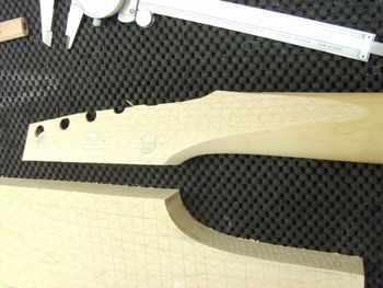 The neck had to be shaved even further in order for the new maple to fit in the proper orientation. Most of the new wood will be removed as the Bass VI headstock is shaped....
