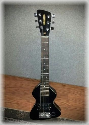 Little Chiquita Travel Guitar. I've had this a long time and have played it onstage in the past. The Low E String is tuned to A so it is A,D,G,B,E,A