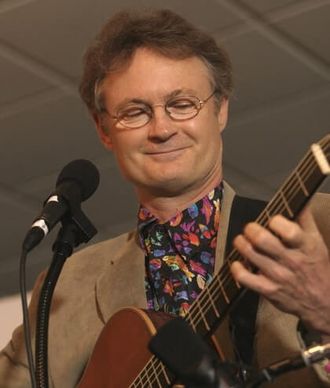 Musical Humorist Greg Tamblyn playing guitar