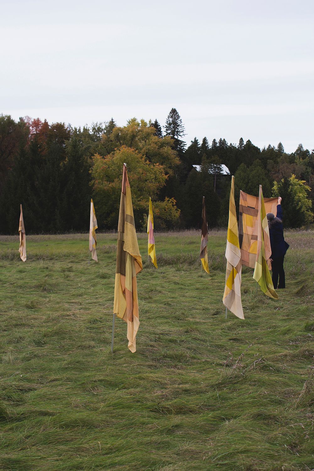 "Infinite Balance", 2021. Naturally dyed silk, wool, cotton, linen, and hemp, flag poles.