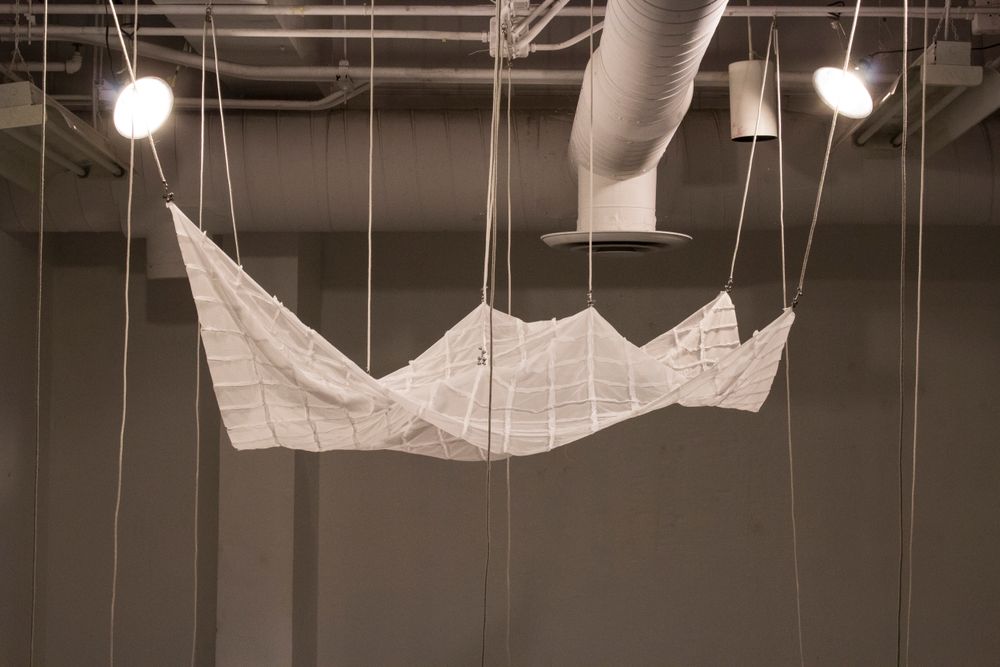 "Ships Seem to Sink as They Move Away From View and Pass the Horizon", 2018, Patchworked polyester fabric, poly-cotton rope, pulleys. Interactive installation.