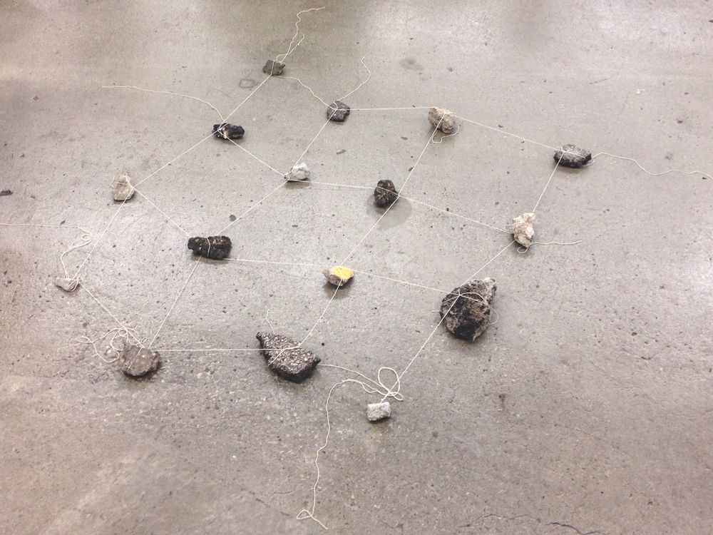 "Coming Together Again (Without the Least Resistance)", 2018. Asphalt and concrete rubble, cotton string. Approx. 4'x4'.