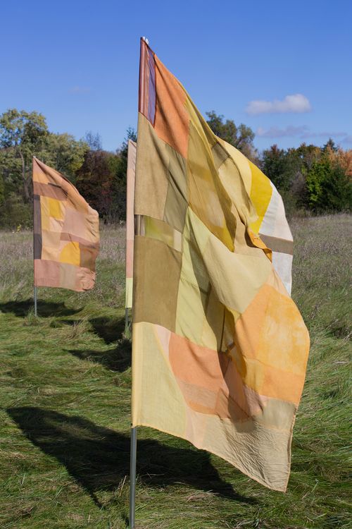 "Infinite Balance", 2021. Naturally dyed silk, wool, cotton, linen, and hemp, flag poles.