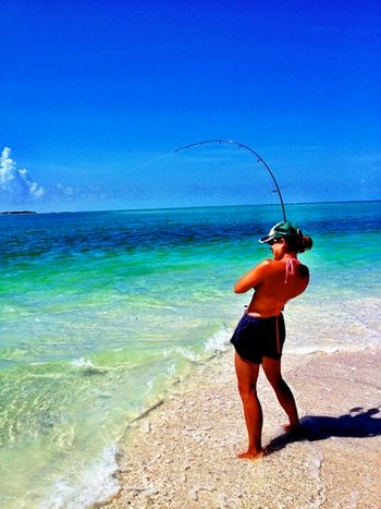 My baby hauling a fish in when we were in Naples..Her first catch..about an 8 lbs. Amberjack..To fun to watch her reel it in..