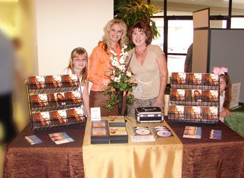 Cathy with Beth, one of our dearest and closest friends, (she manages our product table), and sweet little Caitlin with Cassidy hiding behind the CD rack.
