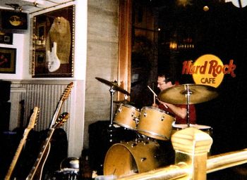 Rob nailing the rhythm for engine14 at Hard Rock Cafe, Washington, DC. Rob's goal is to someday have his drumset and clothes--with Rob in them!!--put inside of a glass-framed display at Hard Rock just like that guitar on the wall....