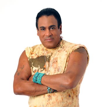 FELIPE ROSE of VILLAGE PEOPLE - Felipe Rose is best known as the co-founder and Native American Indian attired vocalist in the world famous VILLAGE PEOPLE, who are now heading into their third decade as the Ambassadors of Disco. Felipe’s unique style honors the heritage of his Puerto Rican mother and Native American father (Lakota Sioux). Felipe has been called a "shadow walker", a Native term for walking in two worlds. VILLAGE PEOPLE became an instant phenomenon with their mega hits "San Francisco/Hollywood", "Macho Man", "Y.M.C.A.", "In the Navy", "Go West" and more. As the group's founding member, Felipe is much credited with being the inspiration of putting together the group. His keen visual sense and performance experience led to input and direction for the group’s entire concept. Today, the VILLAGE PEOPLE remain a pop culture mainstay of the music scene, touring the world and becoming a family of performers that brings Felipe camaraderie and consistency of life while Felipe also continues his own personal journey of projects and gifts honoring his heritage. In 2001, Felipe "Swift Arrow" Rose co- wrote and co-produced the single, Trail of Tears on Tomahawk Records which was nominated for three Native American Music Awards. Felipe was given the honor of opening the Fifth Annual Native American Music Awards (2002) and brought the crowd to its feet. That evening he took home the Award for Best Historical Recording. In 2003, Felipe released his follow-up effort, We're Still Here: The Virginia Indians Tell Their Story. Nominated for five Native American Music Awards, he and his collaborator Frosty Lawson brought home the award for "Song/Single of the Year". In 2005, Felipe released a tribute CD for the late Thomasina E. Jordan which earned him three Native American Music Awards including "Songwriter of the Year." In January 2005, Felipe donated a gold single of the band's 1978 hit signature song "Y.M.C.A." to the Smithsonian's National Museum of the American Indian in Washington, D. C. "I want to leave something for my indigenous hertitage, " Rose reported to National Public Radio. In February, 2006, he donated the VILLAGE PEOPLE's first gold record, a feathered headdress, and tour jacket from his personal collection to the Seminole Tribe of Florida’s Hard Rock in Hollywood, Florida.