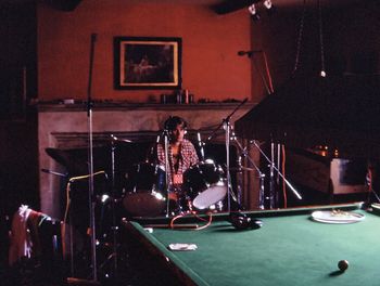 Skip lays down a drum track between the snooker table and a pinball machine in the main house of The Manor.