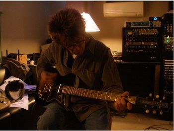 John lays down a part for "Wrong Idea" on his Dan Electro baritone guitar as Psycho the cat watches from the couch.